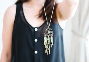 woman holding a necklace